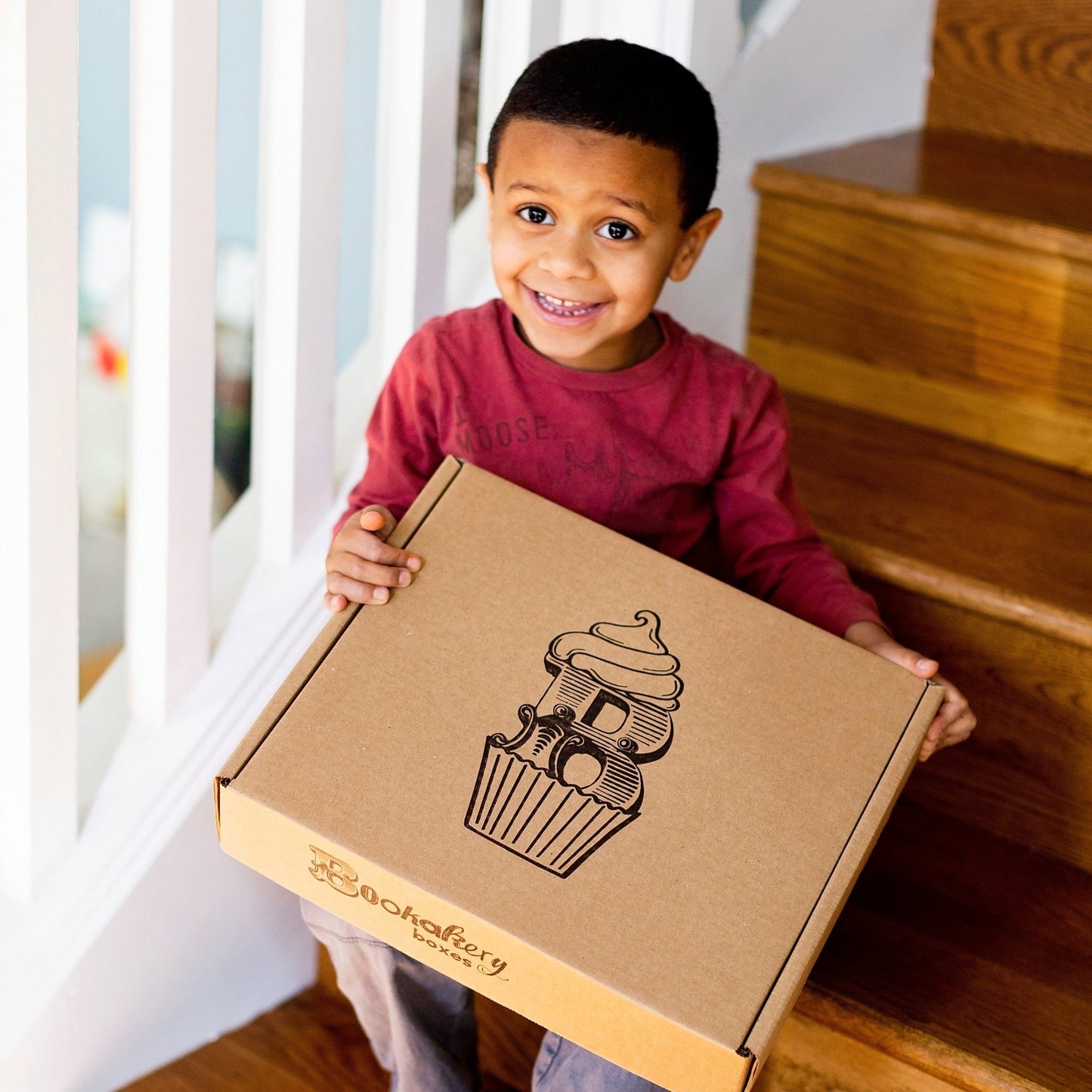 Small boy holding Bookakery Box